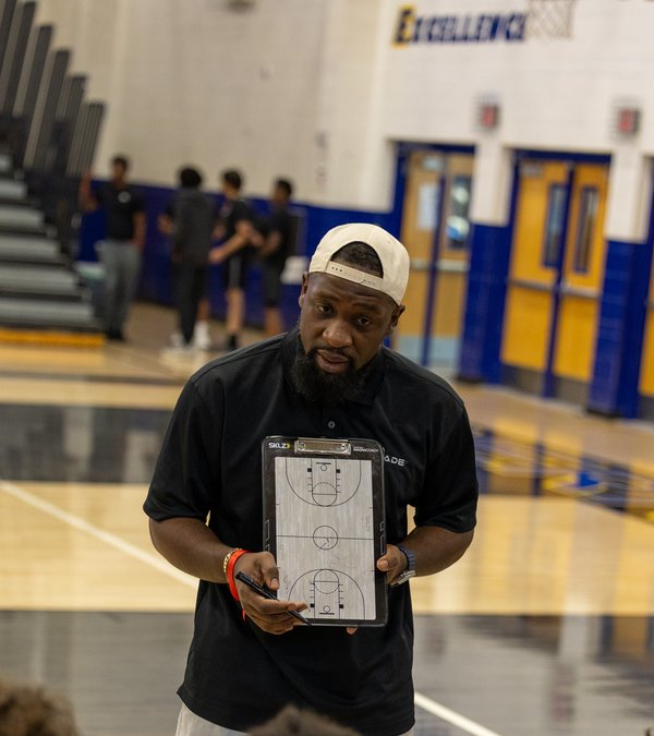 Coach Greg Lewis drawing up a play
